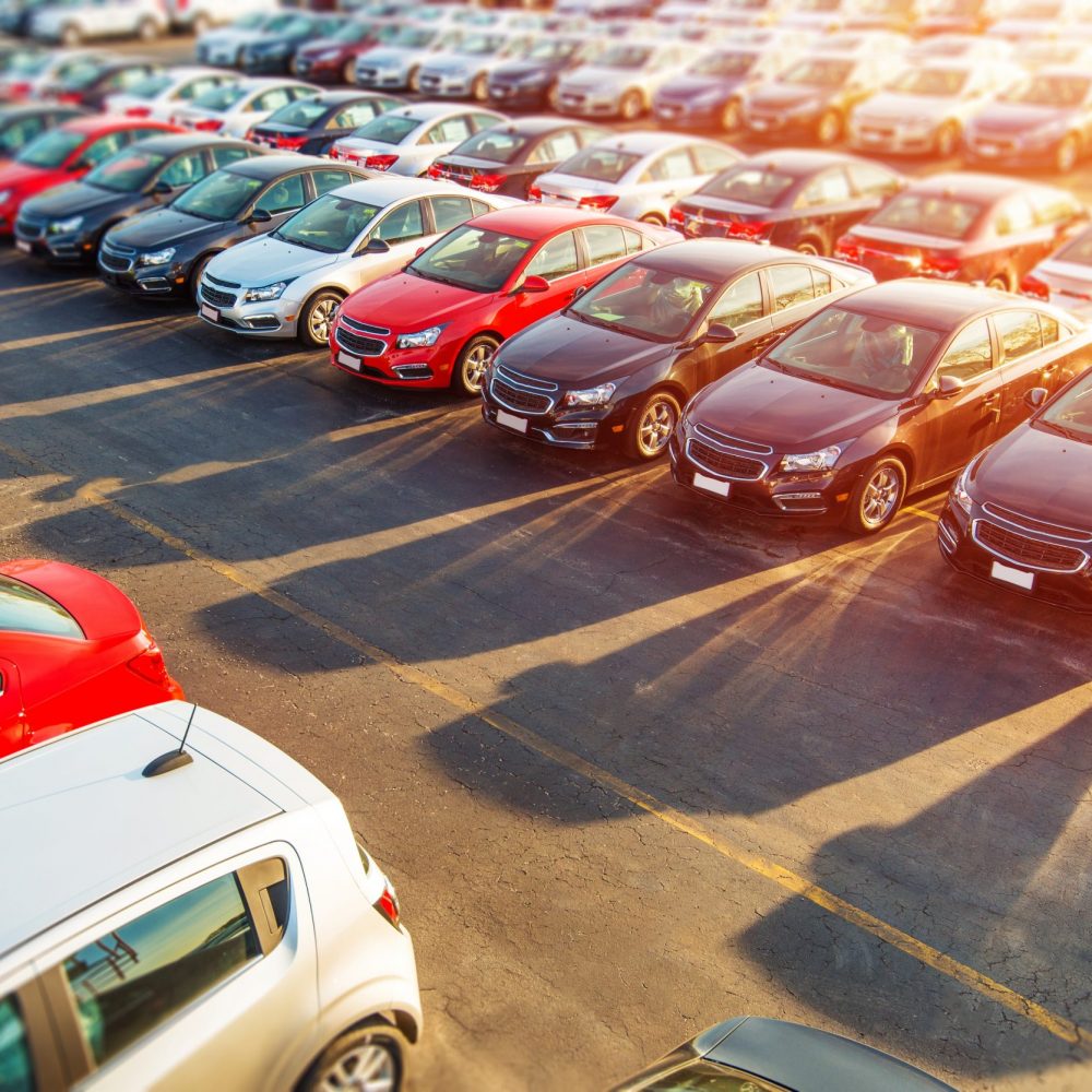 Dealer New Cars Stock. Colorful Brand New Compact Vehicles For Sale Awaiting on the Dealer Parking Lot. Car Market Business Concept.